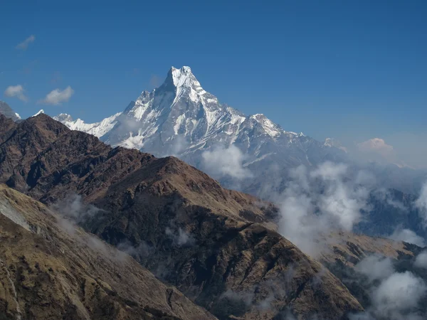 Machapuchare and clouds creeping up the mountains — Stock Photo, Image