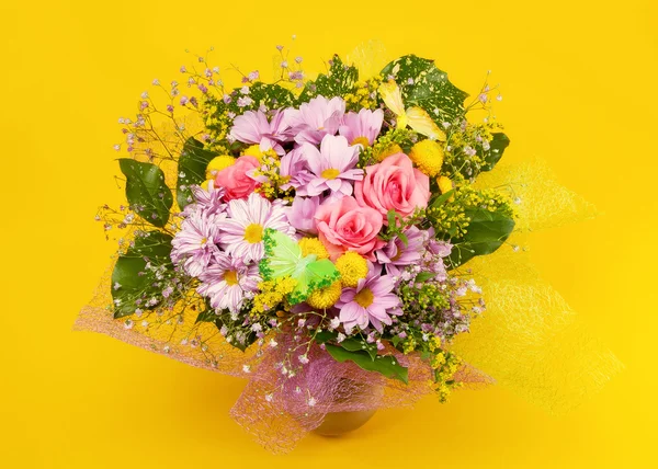 Bunch of flowers on yellow background — Stock Photo, Image