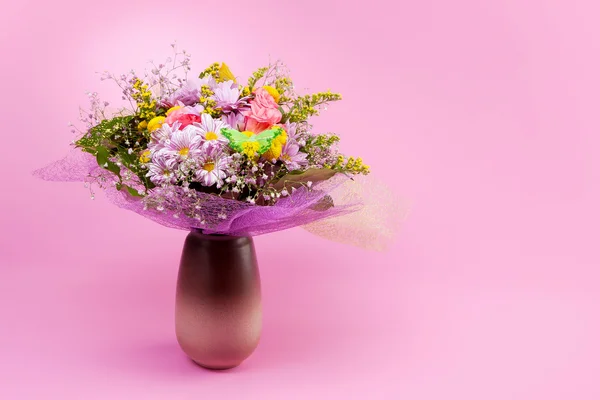Bunch of flowers on pink background — Stock Photo, Image