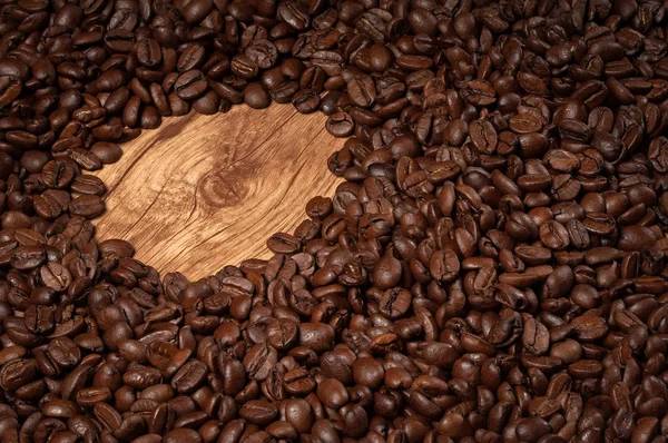 Roasted coffee beans on wooden texture — Stock Photo, Image