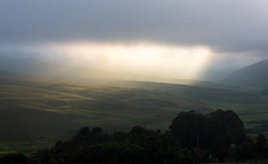 Late afternoon light break through the clouds Drakensberg South Africa