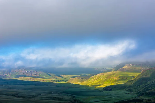 First light of the day break through the clouds Drakensberg South Africa
