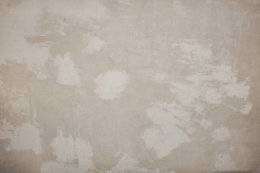 Eski beton duvar dokusu. İnşaat yüzeyi çiziyor. Soyut vintage taşları çatlatmış, kremsi doğal renk, grunge tavan arası, antika tasarım.