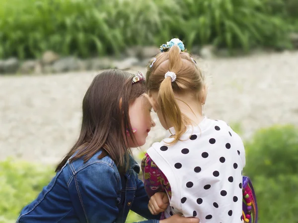 Two girls share secrets — Stock Photo, Image