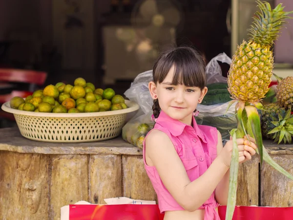Маленькая девочка на фруктах — стоковое фото