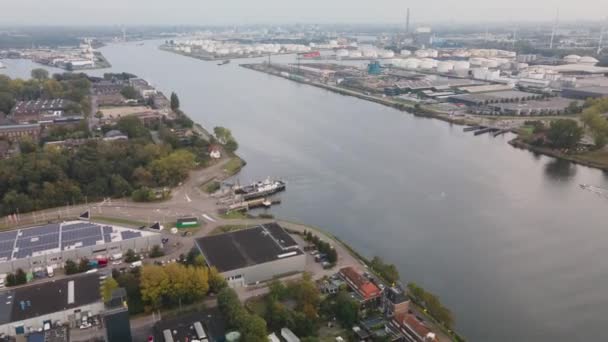 Aerial hyperlapse of a ferry ship going from Amsterdam to Zaandam in Westpoort, the Hemweg. Cars bicycles cars and other traffic crossing a waterway. The Noordzeekanaal — Stock Video