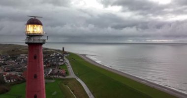 Den Helder 'de deniz feneri kulesi Lange Jaap. Hollanda, Kuzey Hollanda' daki Texel adası yakınlarında deniz boyunca 5K hava aracı görüntüsü..