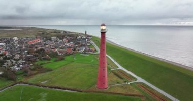 Den Helder 'de deniz feneri kulesi Lange Jaap. Hollanda, Kuzey Hollanda' daki Texel adası yakınlarında deniz boyunca 5K hava aracı görüntüsü..