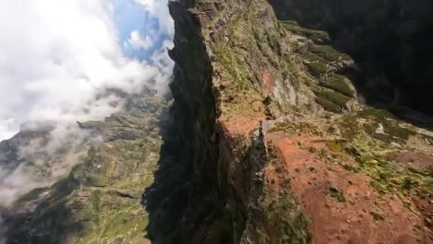 Beautifull mountain surfing FPV drone aerial view, close flying along the cliffs in Madeira. Action sports hiking flying through the clouds. Sunny day. — Stock Video