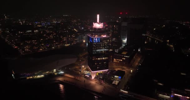 Amsterdam, 13th of November 2021, The Netherlands. Amsterdam Lookout tower at night. Ferries next to the tower. — Stock Video