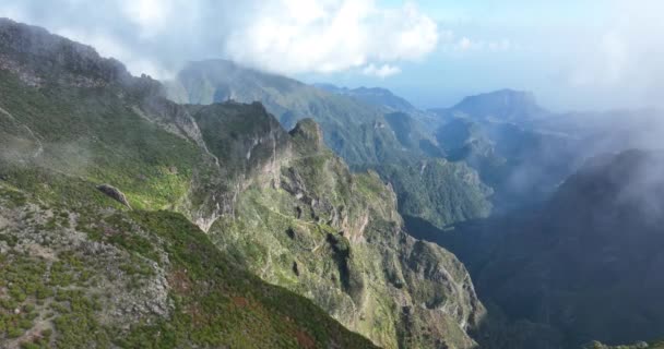 Madeira mountains epic high cliffs in the clouds aerial drone footage with an helicopter view of this beautifull nature landscape. — Stock Video