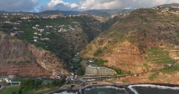 Coastline of Madeira Portugal beautifull sunny island the atlantic ocean aerial drone view. Aerial drone view. Calheta dramatic cliff and mountain landscape. — Stockvideo