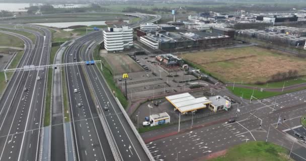 Amsterdam, 1st of January 2022, The Netherlands. McDonalds restaurant building and sign aerial drone view. Along the highway. — Stock Video