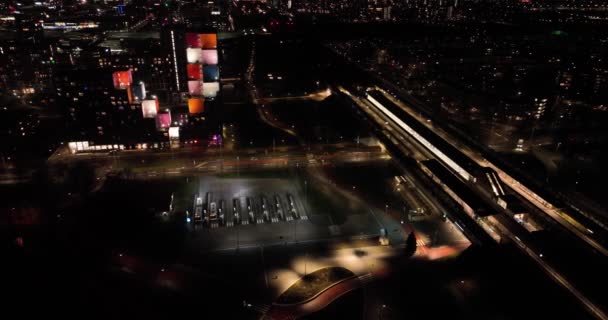 Holendecht train and metro station in Amsterdam Zuid Oost, the Netherlands europe. Dutch infrastructure aerial drone view. Night time — Wideo stockowe