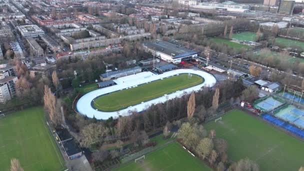 Aerial of a recreational outdoor leisure ice skating rink top down view in Amsterdam, the Netherlands. — Stock videók