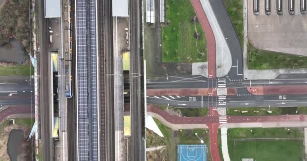 Dutch infrastructure from above, metro train station and road aerial top down view. Holland, The Netherlands. — Vídeos de Stock