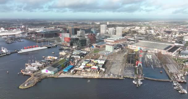 Amsterdam, 2nd of January 2022, The Netherlands. NDSM Werf modern residential apartment buildings construction site in trendy historic industrial site. — Stockvideo