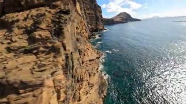 Cliffs aerials mountain aerials FPV racing drone Mountain surfing, and cliff diving along the rocks. Epic mountain landscape and ocean on Madeira island in Portugal. Beautifull nature.