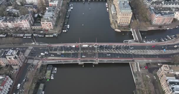 Aerial drone footage of the Amstel river and De Hogesluis Brug 246 in Amsterdam East and city center downtown. Dutch urban infrastructure. — Video