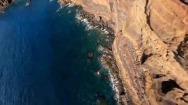 Cliffs aerials mountain aerials FPV racing drone Mountain surfing, and cliff diving along the rocks. Epic mountain landscape and ocean on Madeira island in Portugal. Beautifull nature.