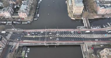 Aerial drone footage of the Amstel river and De Hogesluis Brug 246 in Amsterdam East and city center downtown. Dutch urban infrastructure.
