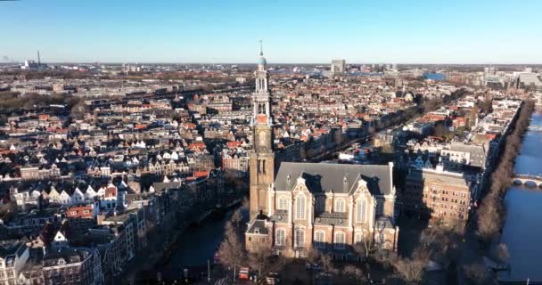 Amsterdam city center aerial drone view of the Westerkerk and the Jordaan urban area in the city center of Amsterdam. Along the canals. — Stock videók