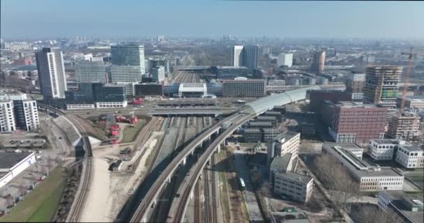 Railway station transportation infrastructure metro train station in Amsterdam Sloterdijk, The Netherlands. Aerial of highway urban transit platform and office buildings skyline. — Stock Video