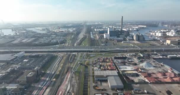 Industrial zone containers factories and businesses in Amsterdam Westhaven, The Netherlands, Europe. Traffic highway and train tracks logistics and harbour. — Stock Video