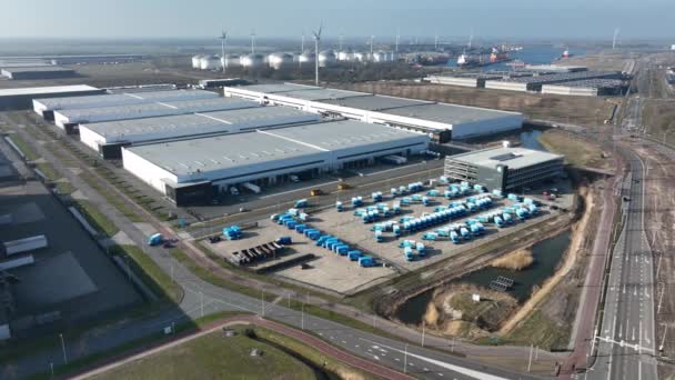 Supply chain distribution logistics depot. Aerial drone view of a commercial warehouse delivery trucks distribting merchandise. Amsterdam, The Netherlands. — Stock Video