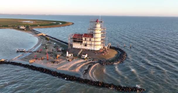 Aerial view of the Paard van Marken at sunrise traditional historic monument lighthouse on the island of Marken in The Netherlands. Small fishing village in Europe. — Stock Video