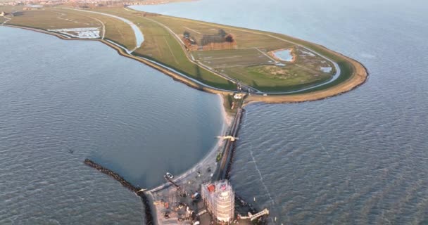 Aerial view of the Paard van Marken at sunrise traditional historic landmark monument light house on the shore of the island of Marken in The Netherlands. — Stock Video