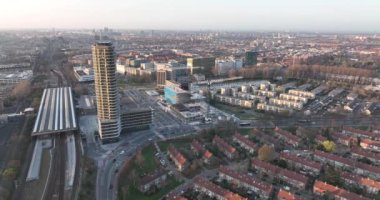 Amsterdamn Amstel kentsel hava aracı görüntülü ulaşım ve kentsel konut kuleleri. Altyapı tren istasyonu iş binaları ve ufuk çizgisi. Su kanalı.