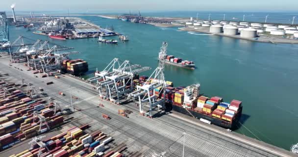 Rotterdam, 18th of april 2022, The Netherlands. Container terminal logistic ship loading and unloading of import and export dock commercial harbour aerial drone view. freight business — стоковое видео