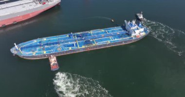Rotterdam, 18 Nisan 2022, Hollanda 'da. Ham Petrol Tankeri gemisi Alhani bir römorkör gemisiyle limana yanaşıyor. Hava aracı görünümü