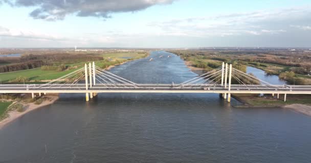 Tacitusbrug bij Ewijk modern suspension bridge crossing the river Waal near Nijmegen, the Netherlands Holland Europe. Valburg and Ewijk. Traffic highway over waterway. Holland. — Stock Video