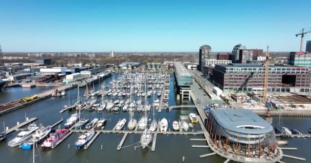 Ámsterdam, 19 de marzo de 2022, Países Bajos. muelle NDSM moderno astillero industrial y zona residencial de moda. Amsterdam Noord a lo largo del río Ij y la vía navegable. — Vídeo de stock