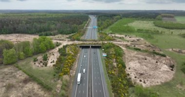 Ecoduct ecopassage or animal bridge crossing over the A12 highway in the Netherlands. Structure connecting forrest ecology landscape over the freeway