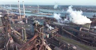 Heavy industrial factory plant facility. Engineering founding steel works blast furnace chimney industry production technology plant. Aerial drone view.