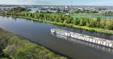 Passenger cruise ship ferry barge vessel. Sailing inland journey city trip cruise trip. European cruise sailing through the Amsterdam-Rijnkanaal near Amsterdam. Aerial drone view.