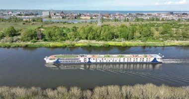 Passenger cruise ship ferry barge vessel. Sailing inland journey city trip cruise trip. European cruise sailing through the Amsterdam-Rijnkanaal near Amsterdam. Aerial drone view.
