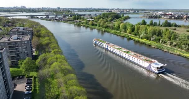 Passenger cruise ship ferry barge vessel. Sailing inland journey city trip cruise trip. European cruise sailing through the Amsterdam-Rijnkanaal near Amsterdam. Aerial drone view. — Stock video