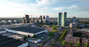 Utrecht skyline and central station public transport infrastructure and business district. Aerial drone overhead view. Tall buildings and towers downtown.
