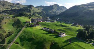 Fronalpstock Klingenstock Stoos in central Switzerland a small wintersport ski resort village. Grassland alps alpine town on a clear sunny summer day. Clear mountain air and sky. Aerial.