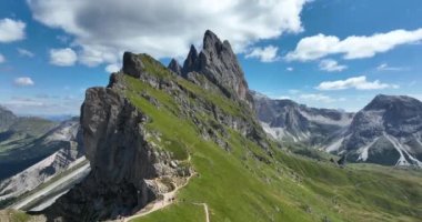 The Dolomites mountain range Italy part of the Southern Limestone Alps. Mountain aerial Hiking trekking majestic rugged cliffs with green grass. Unesco world heritage landscape.