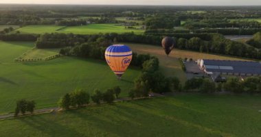 Barneveld, 3th of August 2022, The Netherlands. Bas Balloon rides. Balloon sailing landing in farm grassland field. Hot air balloon aircraft. Propelled by wind.