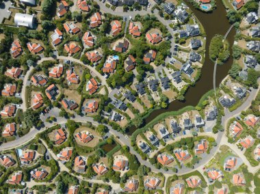 Vacation bungalow park accomodation leisure resort in Zeeland, The Netherlands. Summer cabin village cottage overhead drone aerial to spend holidays.