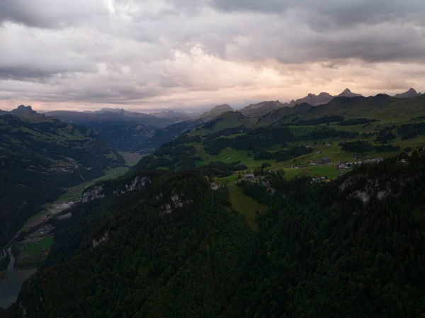 Swiss mountain village Stoos at sunset aerial drone overview in canton of Schwyz. Hiking village near Fronalpstock ridge hike.