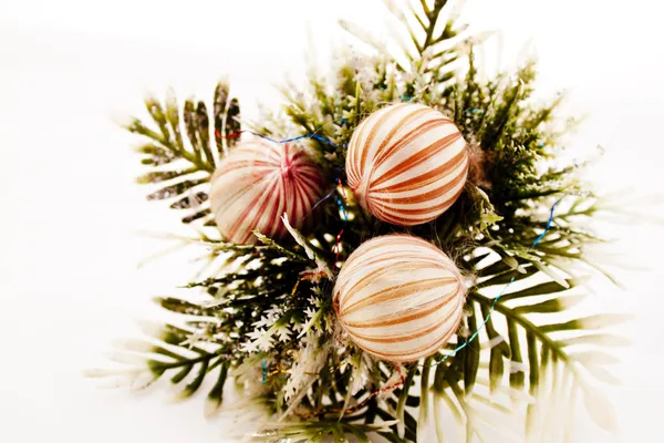 Three Decorative Baubles On Sprig Of Leaves — Stock Photo, Image