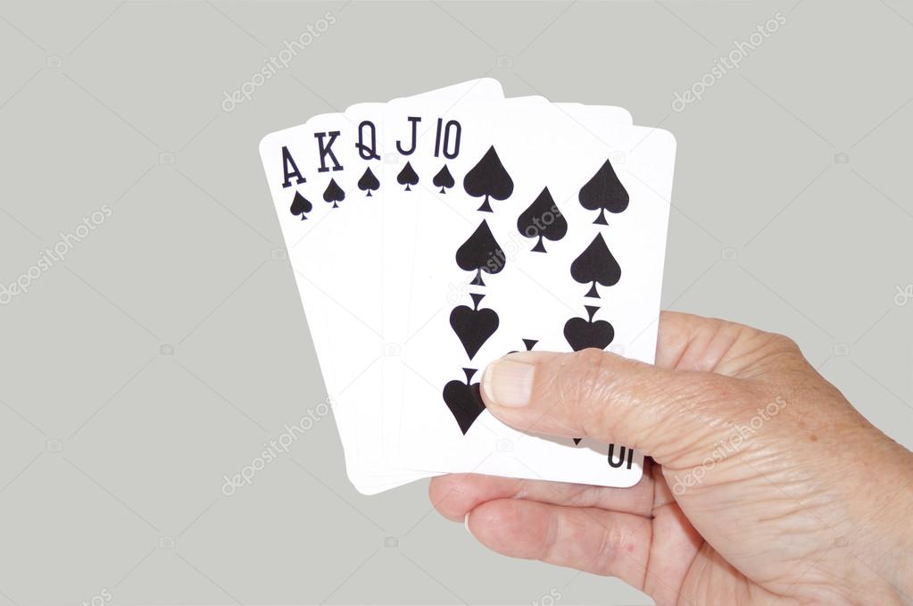 Isolated Hand Held Royal Flush Of Spades