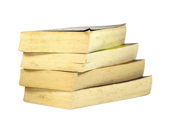 Стопка из четырех старых желтоватых книг в мягкой обложке — стоковое фото